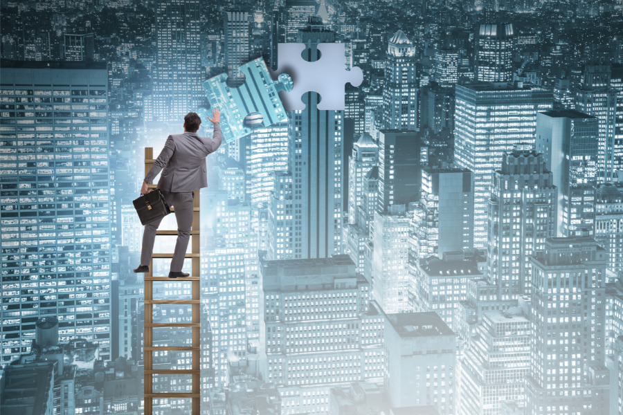 man on ladder placing last puzzle piece